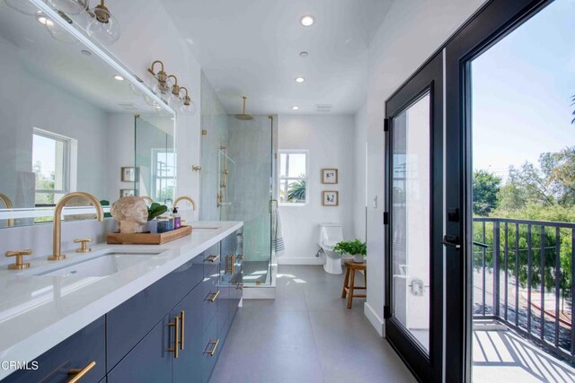 bathroom with an enclosed shower, tile patterned floors, vanity, and a healthy amount of sunlight