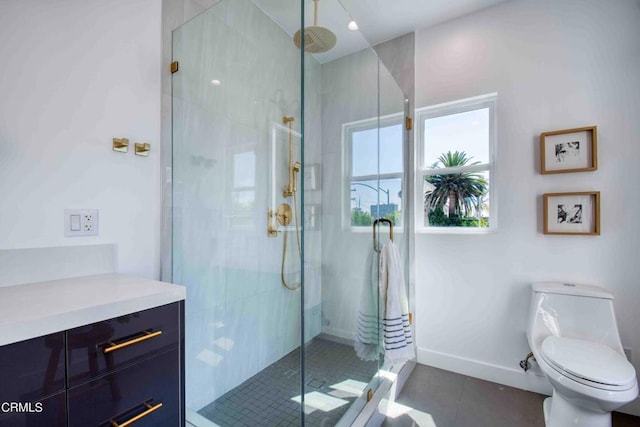 bathroom featuring tile patterned floors, a shower with door, vanity, and toilet