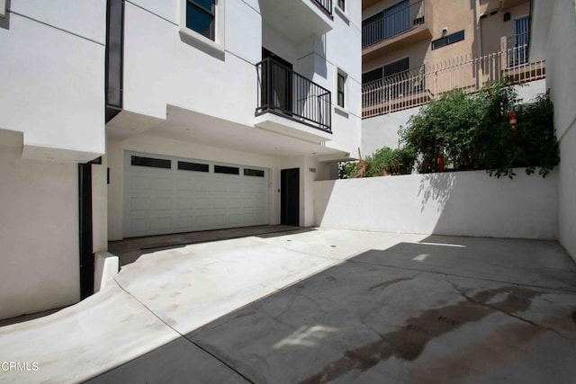 exterior space with a garage and a balcony