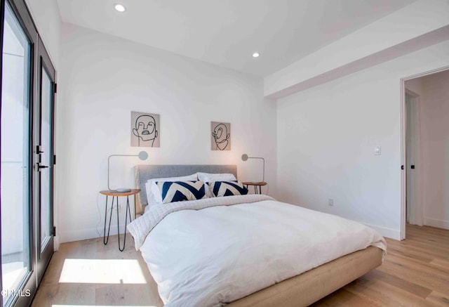 bedroom featuring light hardwood / wood-style flooring and multiple windows