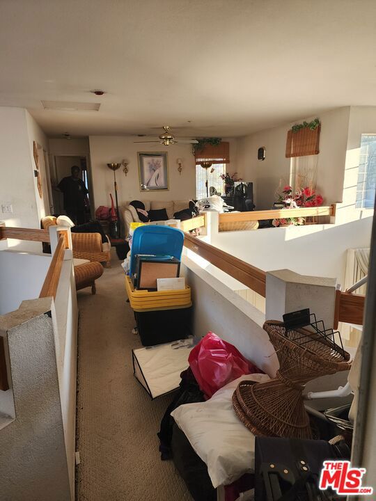 living room featuring carpet flooring and ceiling fan