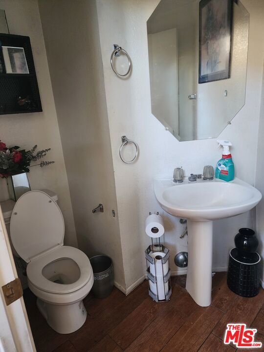 bathroom with toilet and wood-type flooring