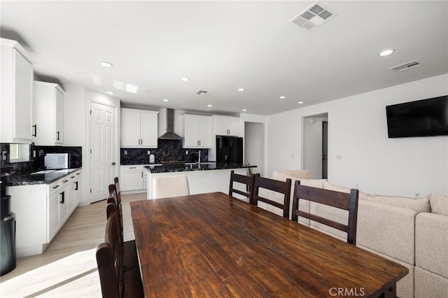 dining room with sink and light hardwood / wood-style floors