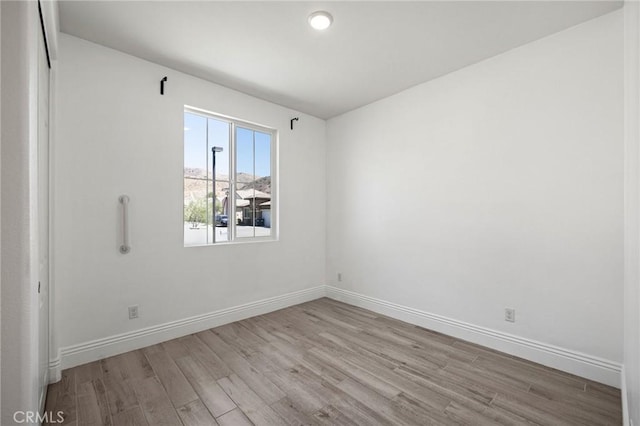 spare room with light wood-type flooring