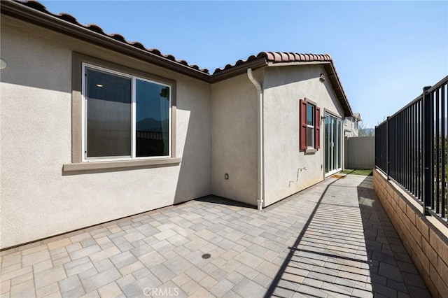 view of side of home with a patio area