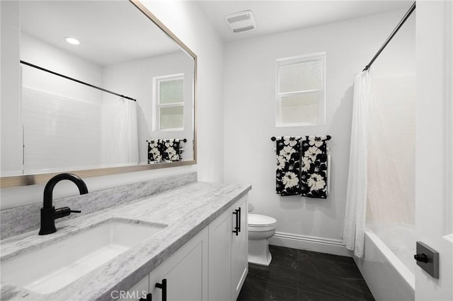 full bathroom featuring shower / bath combo, toilet, and vanity