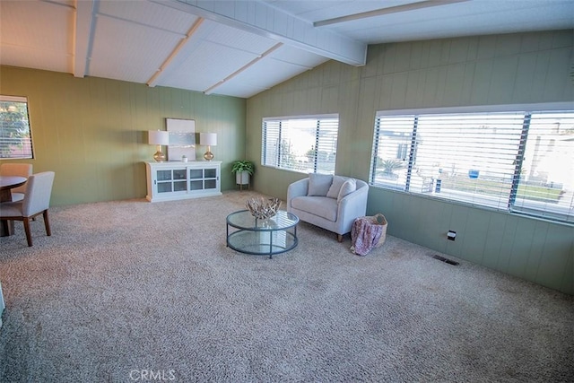 living room featuring vaulted ceiling with beams and carpet flooring