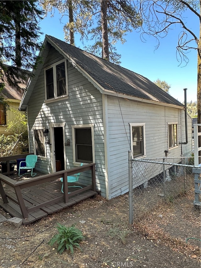 rear view of house featuring a deck