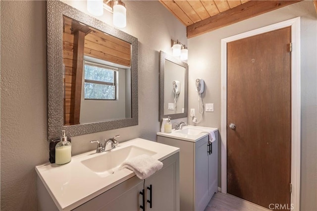 bathroom with vanity and wooden ceiling