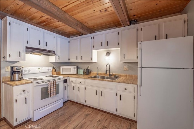 kitchen with white appliances, white cabinetry, and sink