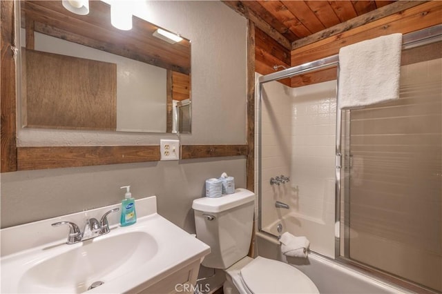 full bathroom featuring vanity, toilet, wooden ceiling, and bath / shower combo with glass door