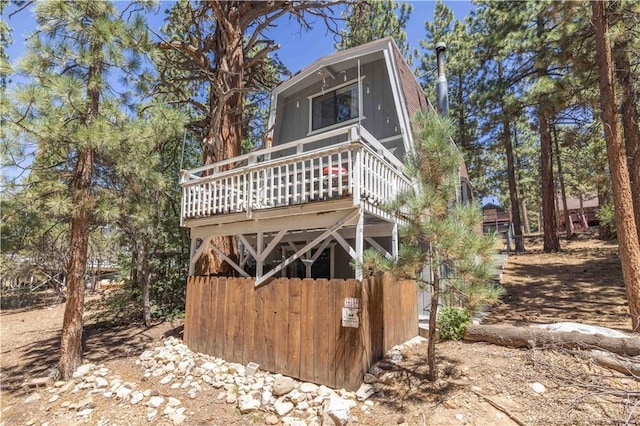 rear view of property featuring a wooden deck