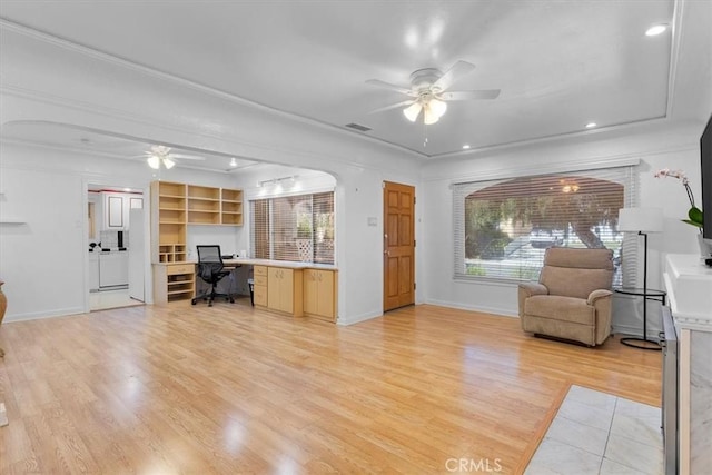 living room featuring ceiling fan, plenty of natural light, and light hardwood / wood-style flooring