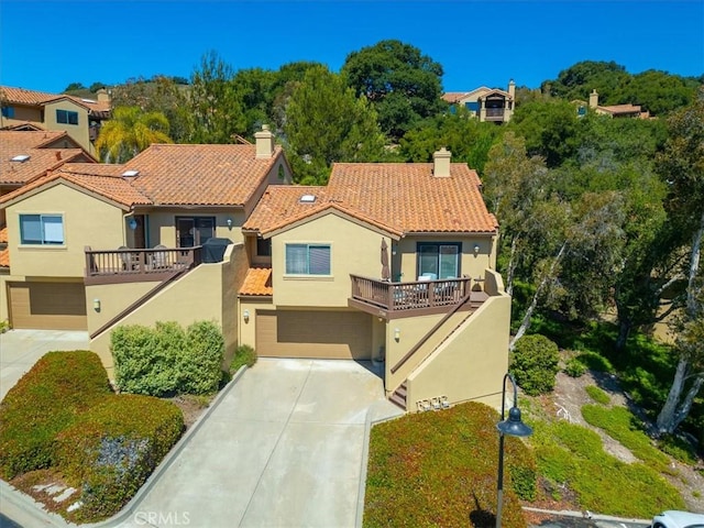 view of front of property with a balcony and a garage