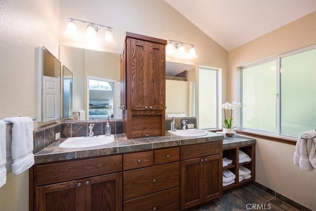 bathroom featuring vanity and vaulted ceiling