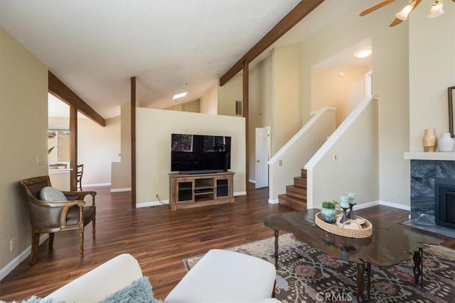 living room featuring vaulted ceiling with beams, dark hardwood / wood-style flooring, and a high end fireplace