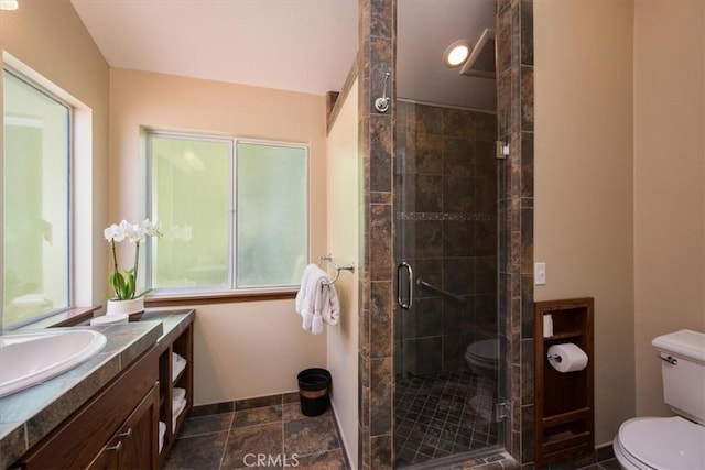 bathroom featuring vanity, toilet, and an enclosed shower