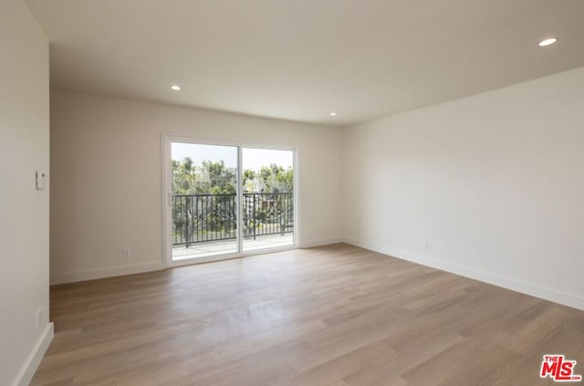 spare room featuring wood-type flooring