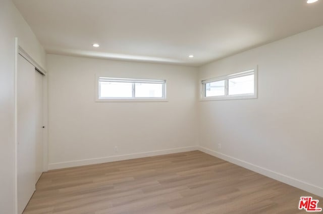 unfurnished room featuring light hardwood / wood-style floors and a healthy amount of sunlight