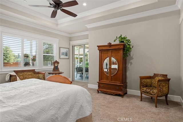 bedroom featuring access to exterior, a raised ceiling, ornamental molding, and light colored carpet