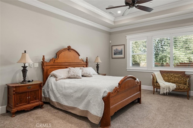 bedroom with light carpet, a tray ceiling, crown molding, and ceiling fan