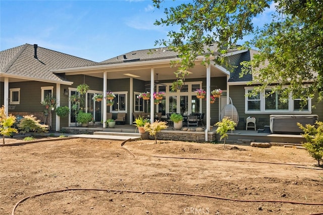 back of property featuring ceiling fan and a patio