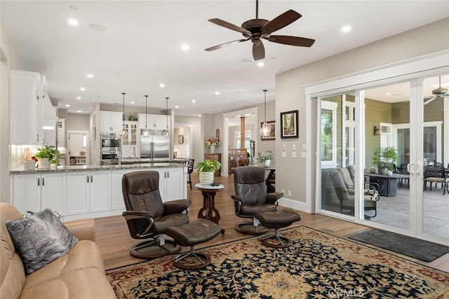 living room with ceiling fan, french doors, and wood-type flooring