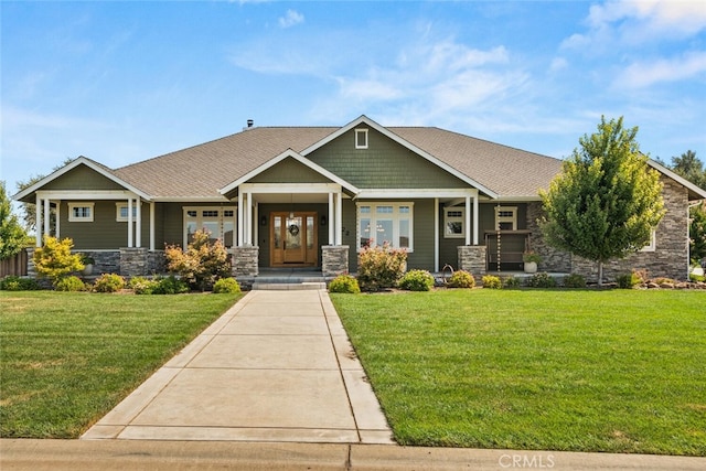 craftsman house with a front lawn and stone siding