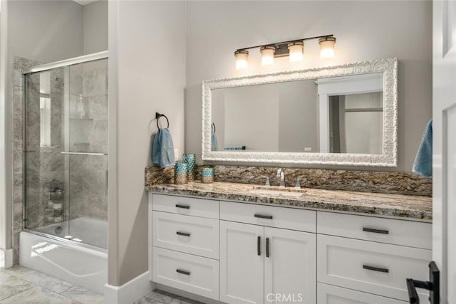 bathroom featuring tile patterned floors, vanity, and combined bath / shower with glass door