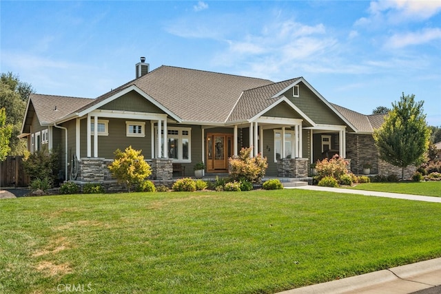 craftsman-style house with a front yard and covered porch