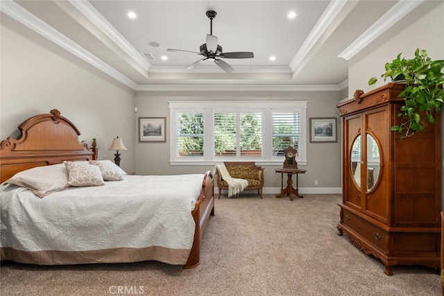 carpeted bedroom with crown molding, ceiling fan, and a raised ceiling