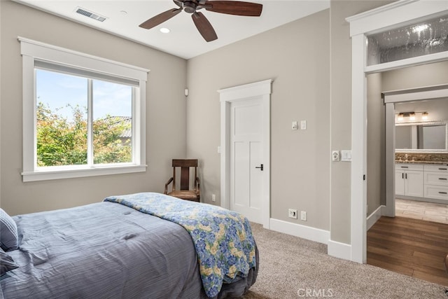 bedroom featuring connected bathroom, ceiling fan, and carpet