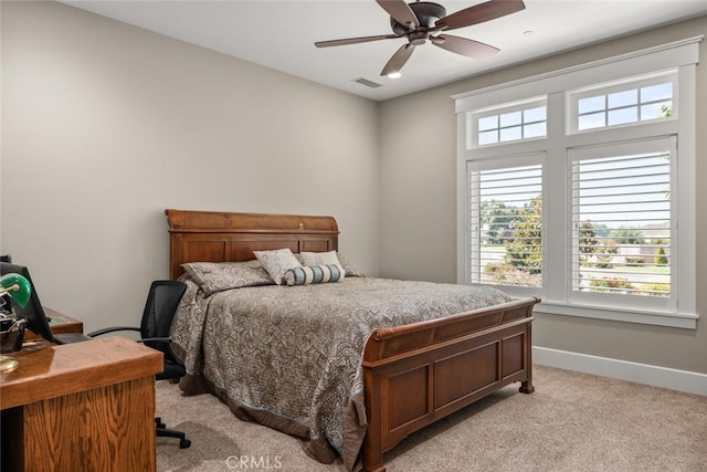 bedroom with ceiling fan, baseboards, light colored carpet, and visible vents