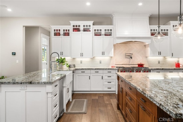 kitchen with stainless steel gas stovetop, white cabinets, brown cabinets, and dark wood finished floors