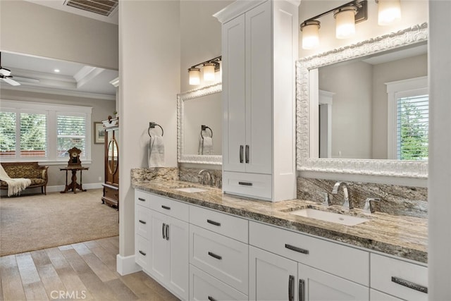 bathroom featuring hardwood / wood-style flooring, ornamental molding, ceiling fan, and a wealth of natural light