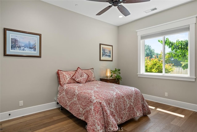 bedroom with ceiling fan and dark hardwood / wood-style flooring