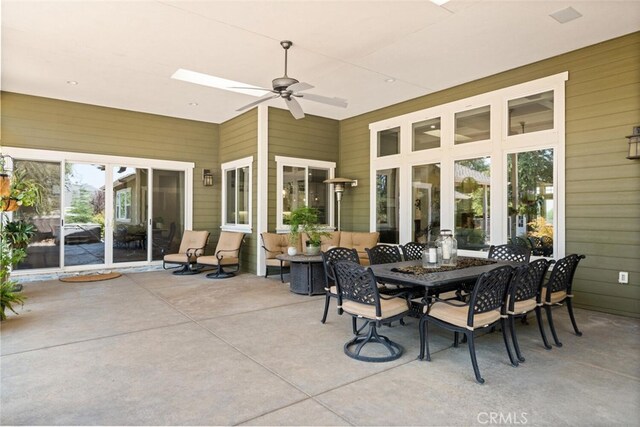 sunroom / solarium featuring ceiling fan