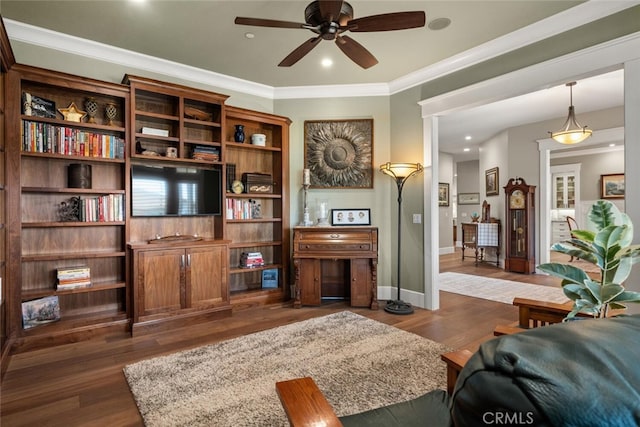 living room featuring ceiling fan, dark hardwood / wood-style floors, and ornamental molding