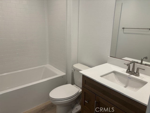 full bathroom featuring vanity, washtub / shower combination, toilet, and hardwood / wood-style floors