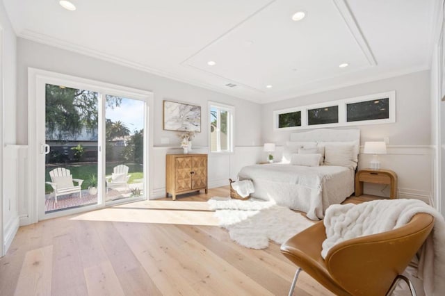 bedroom featuring ornamental molding, light hardwood / wood-style flooring, and access to outside