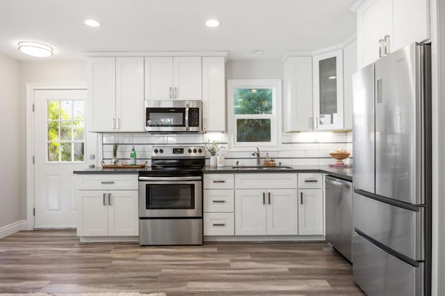 kitchen featuring appliances with stainless steel finishes, sink, and white cabinets