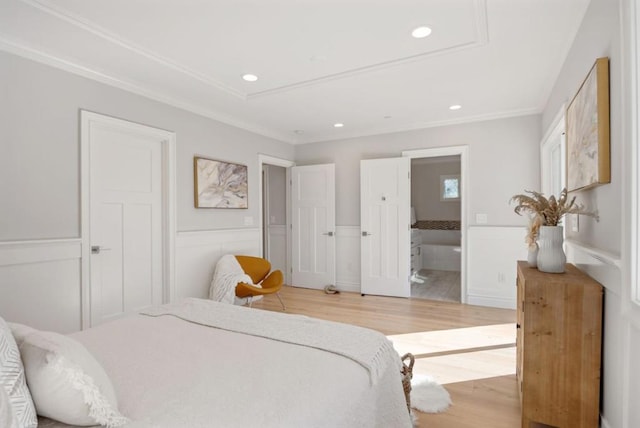 bedroom with connected bathroom, crown molding, and light hardwood / wood-style floors