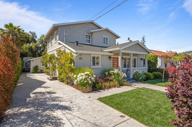 view of front of house with a front yard and covered porch