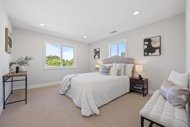 carpeted bedroom featuring multiple windows