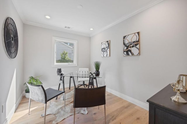 living area featuring crown molding and hardwood / wood-style floors