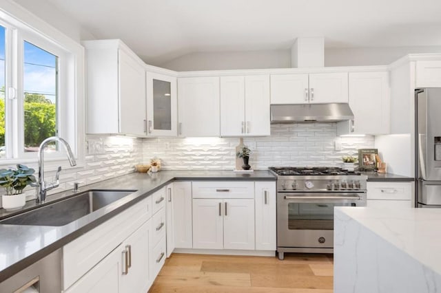 kitchen featuring white cabinetry, appliances with stainless steel finishes, sink, and light wood-type flooring