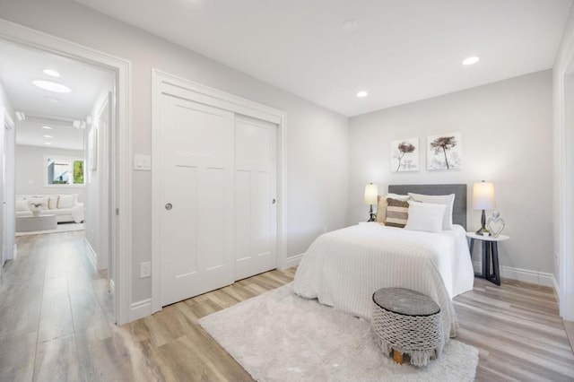 bedroom featuring a closet and light wood-type flooring