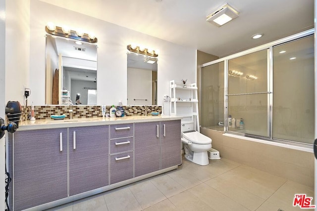 full bathroom with combined bath / shower with glass door, tasteful backsplash, tile patterned floors, and toilet