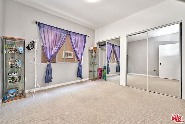 unfurnished bedroom with carpet and multiple closets