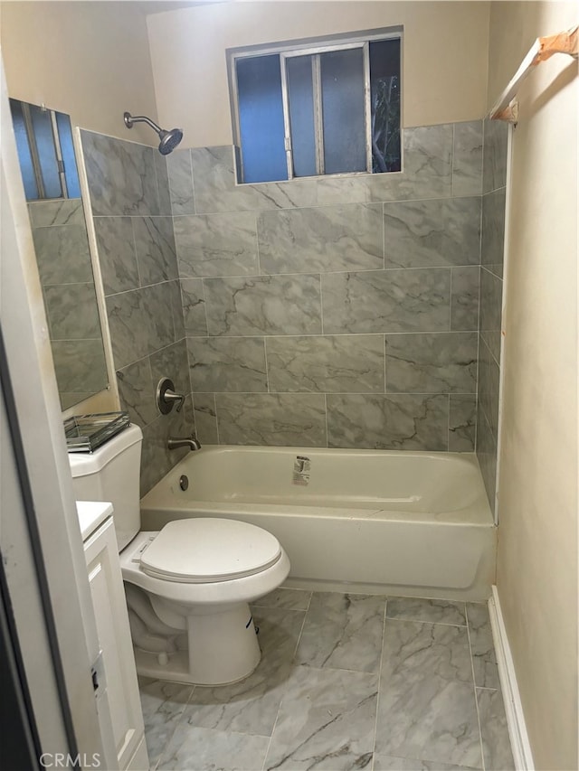 full bathroom featuring tile patterned floors, vanity, tiled shower / bath, and toilet